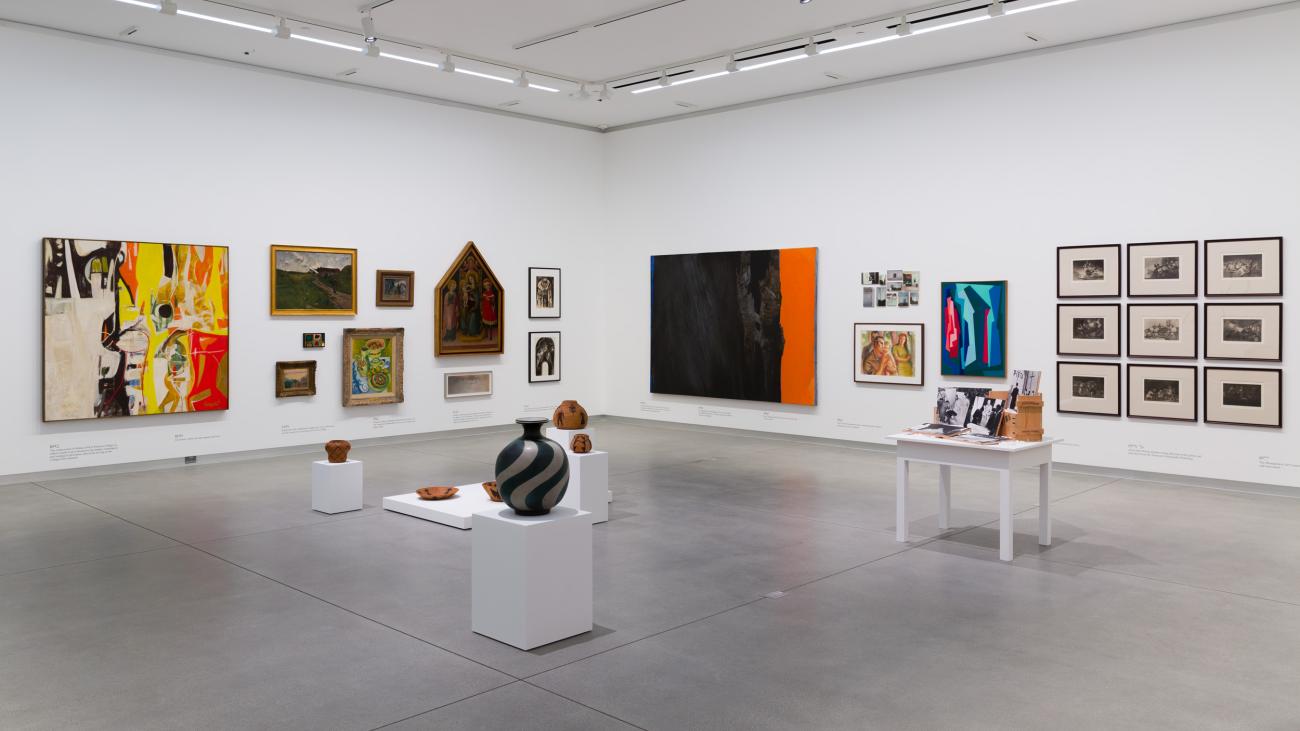 Museum gallery with artwork on walls and pedestals