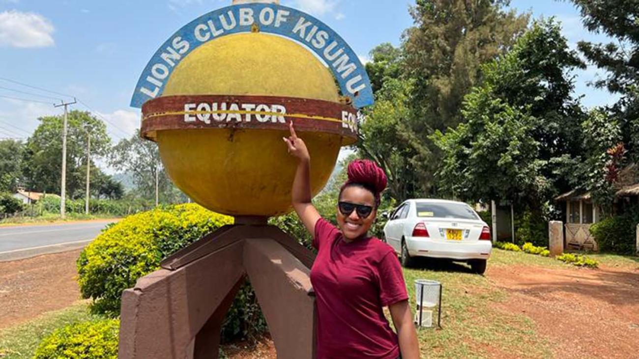 Kiya Henderson '23 at equator marker in Kenya.