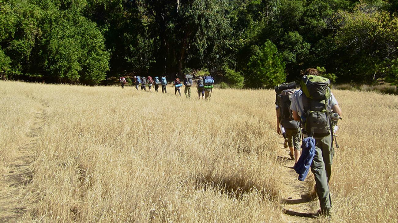 Students Hiking Across a Field
