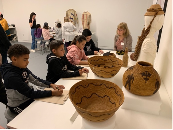 View of third graders interacting with baskets 