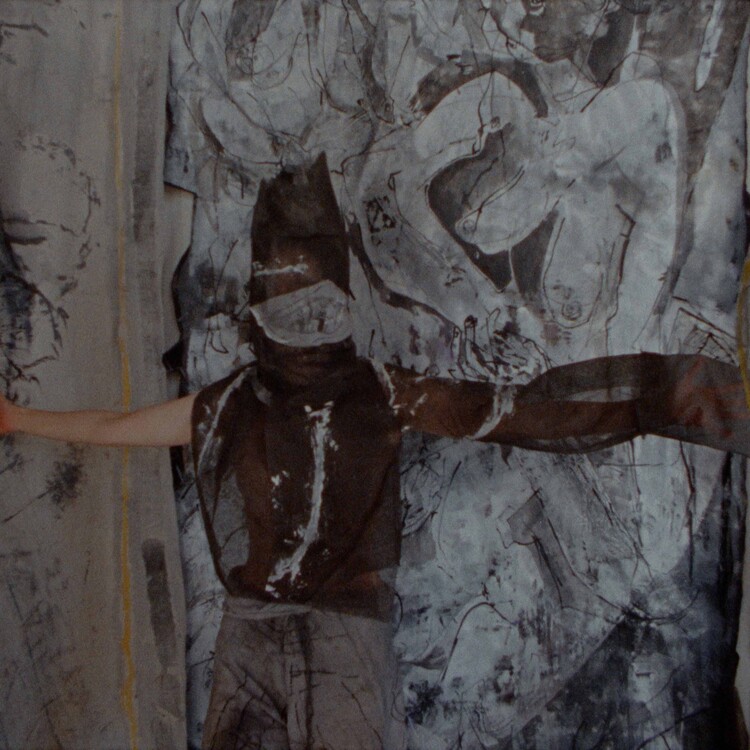 person covered in gauze and canvas with arms outstretched