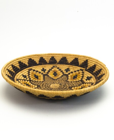 Hemispherical basket with a flat base. Coiled construction. Six-color decorative motif based on a central seven-pointed star.