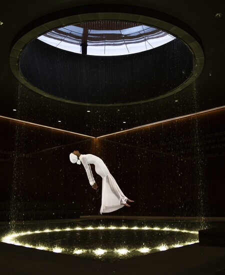 woman in white floating in black room