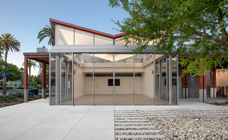 courtyard view of pavilion looking inside past glass sliding doors