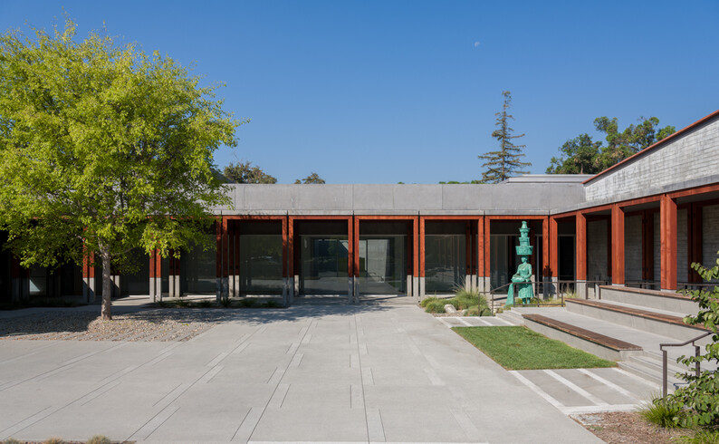 Courtyard view with tall bronze sculpture 