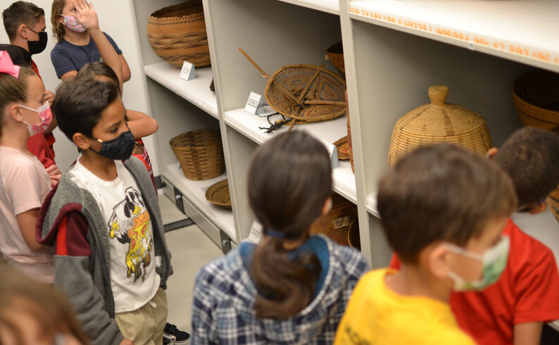 kids in front of native baskets