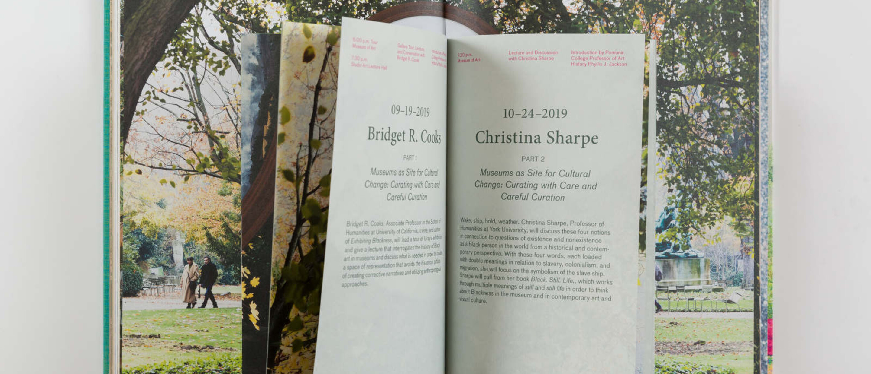Booklet shown inside a book with pages open as spread