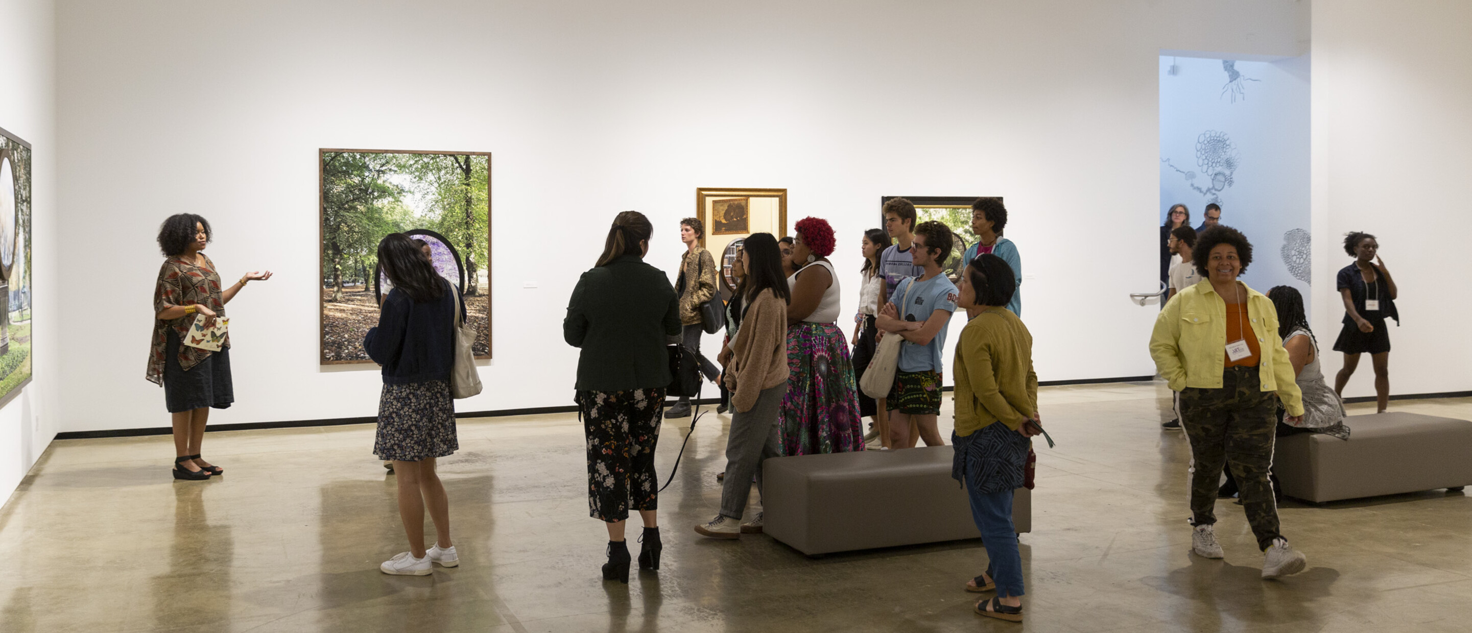 Group of people inside a gallery following an exhibition tour