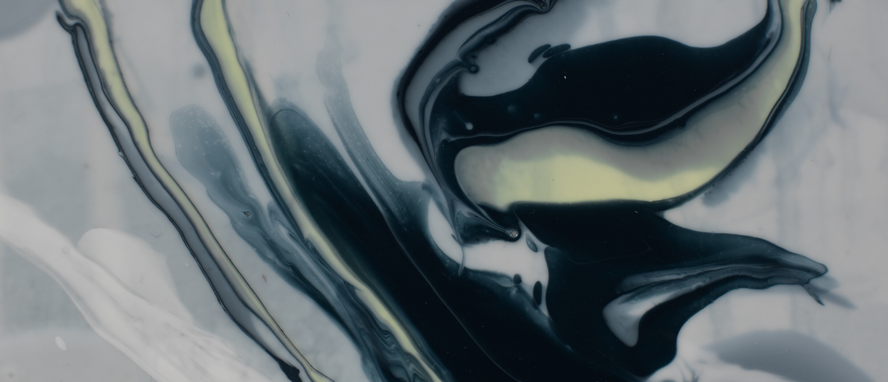 close up of a painting with monochromatic shiny paint that looks like it's fluid and moving