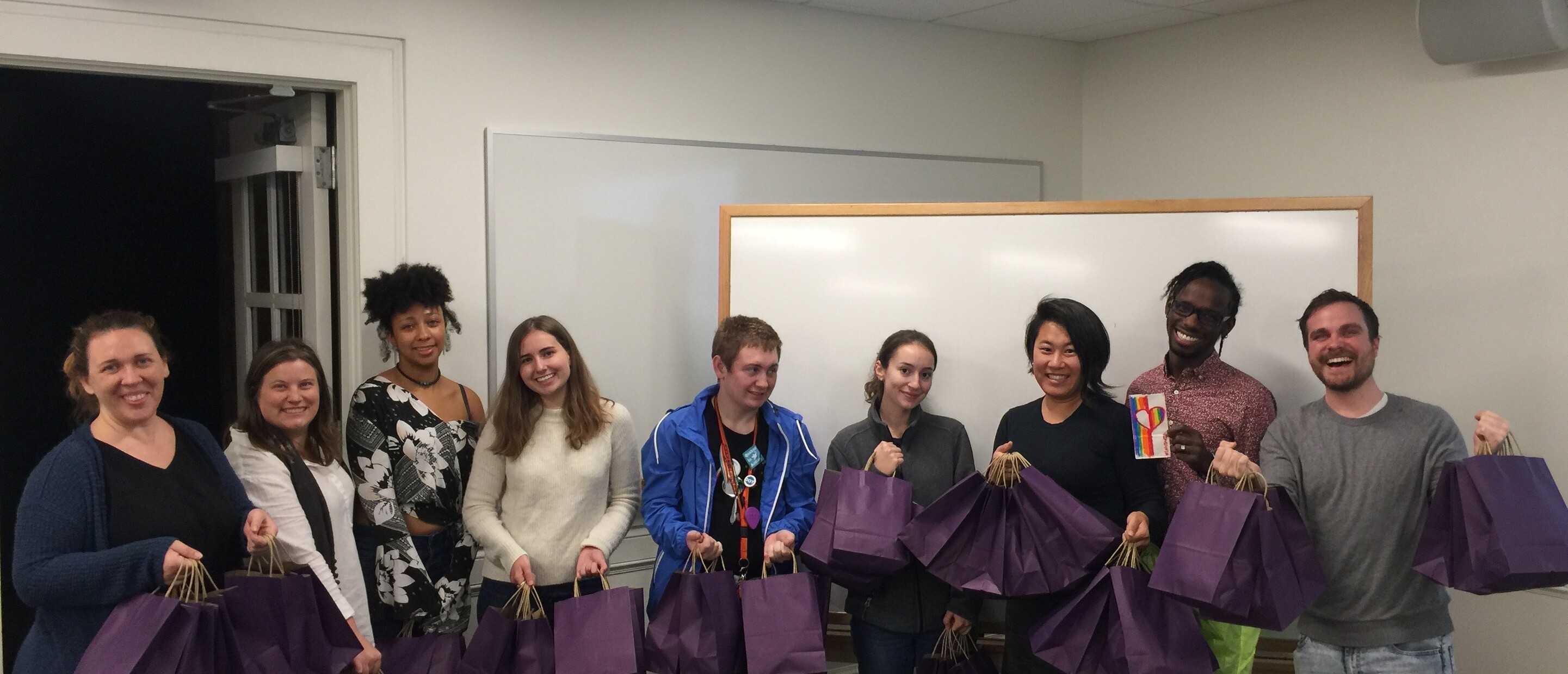 Group of people holding care bags