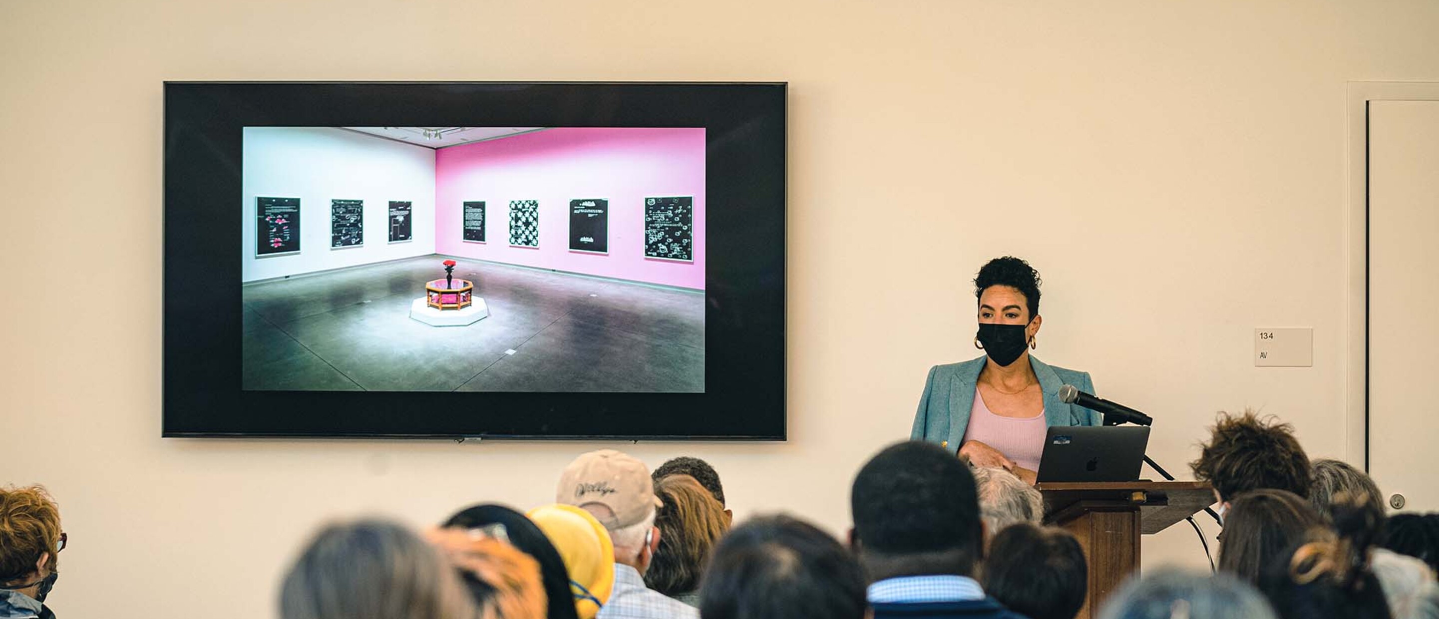 Artist giving a lecture in front of audience.