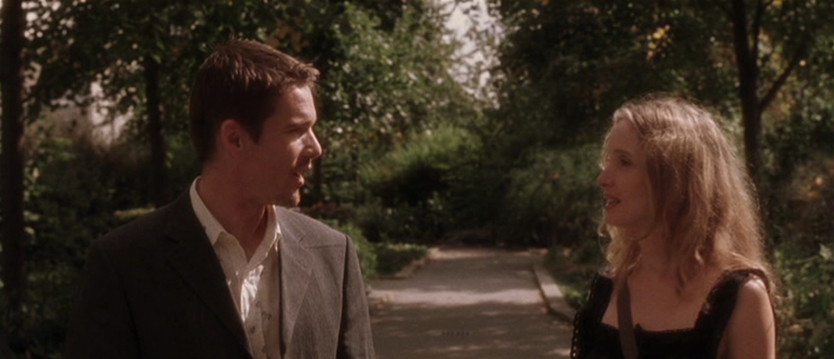 man and woman on walking path looking at each other