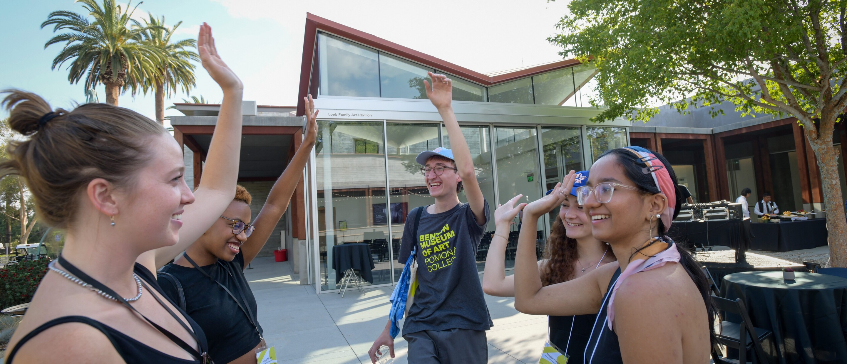 group of students high-fiving in the courtyard