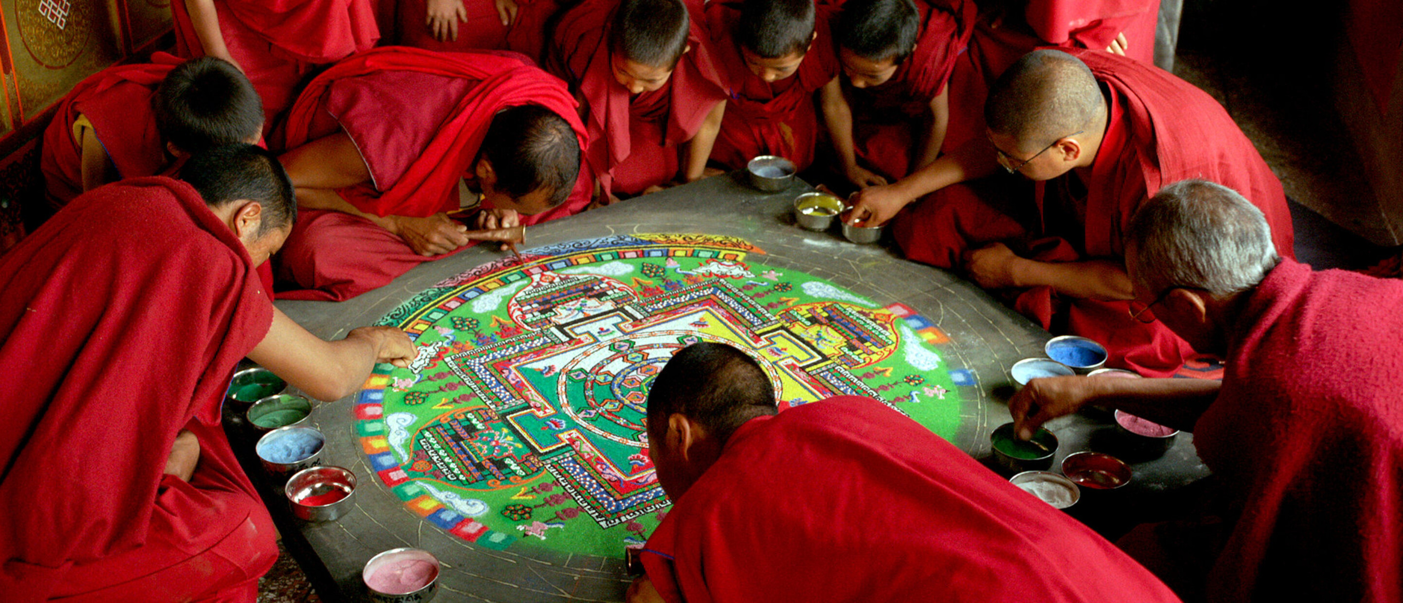 monks creating sand mandala