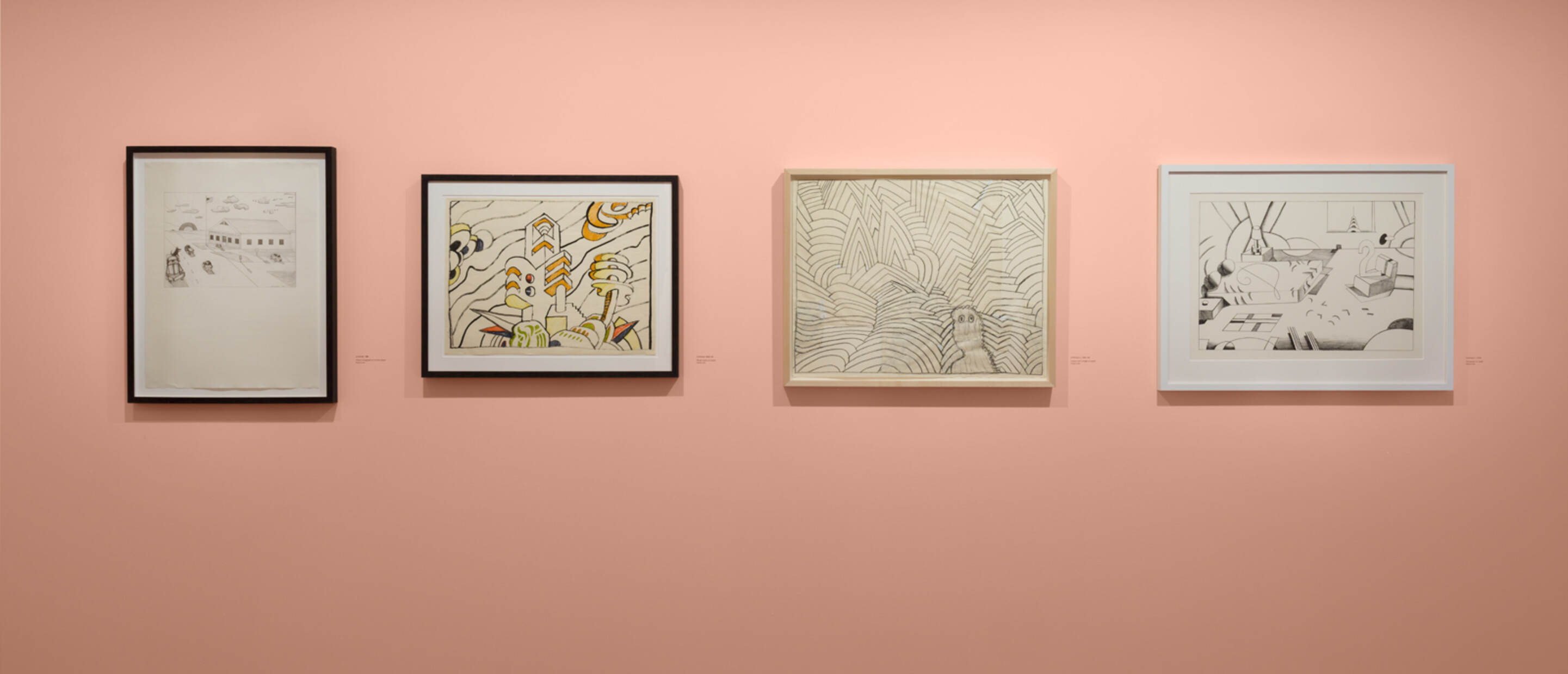 medium shot of framed drawings on pink wall