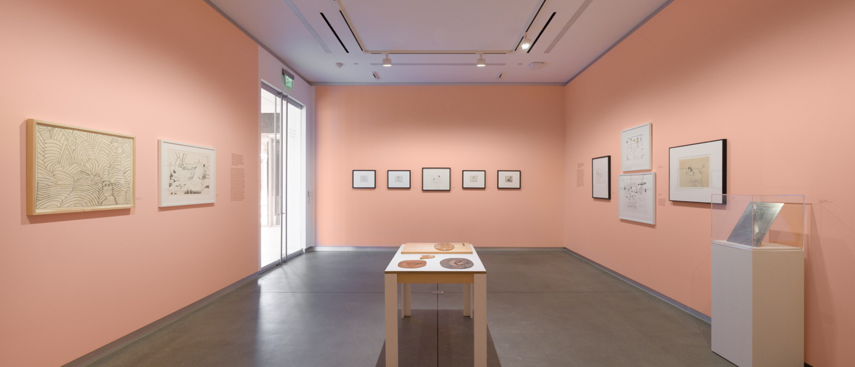wide shot of gallery with pink walls