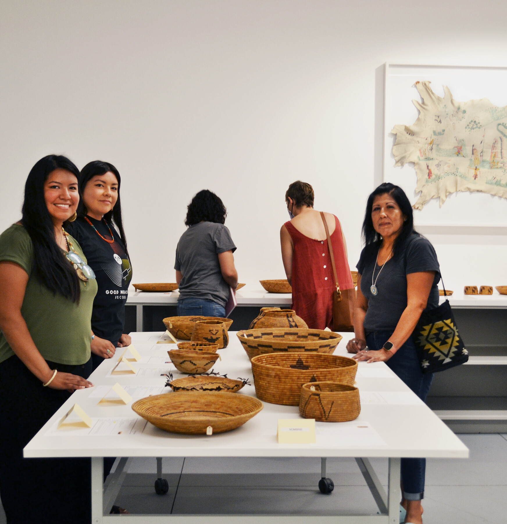 group of women standing around table with baskets