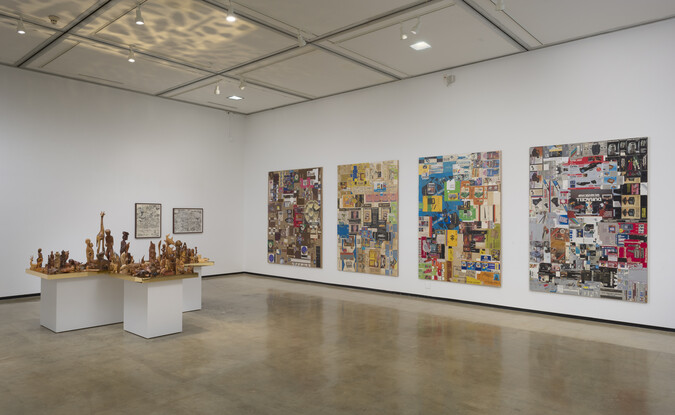 Installation view of R.S.V.P. Los Angeles with 4 multi-media works on the wall and table with multiple wooden sculptures