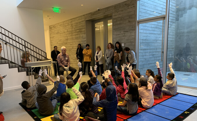 Classroom of 3rd graders in the collections study room area with museum staff