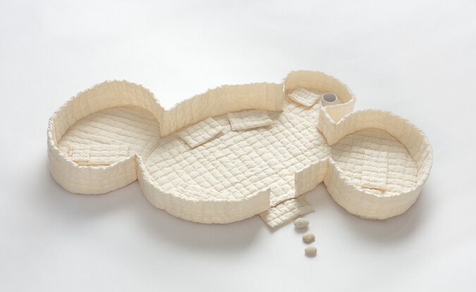 sculpture of cushioned fabric outlining of abstract house