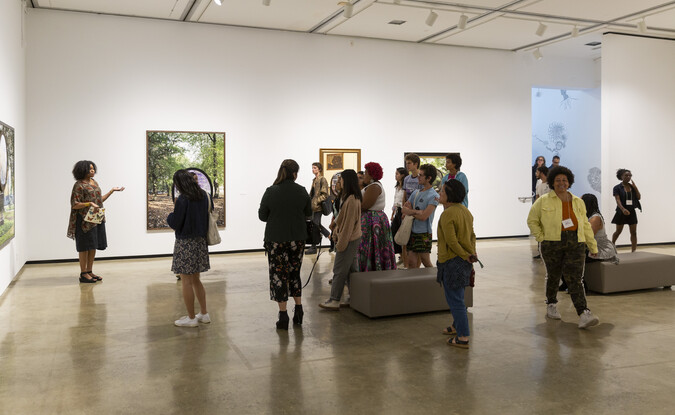 Group of people inside a gallery following an exhibition tour