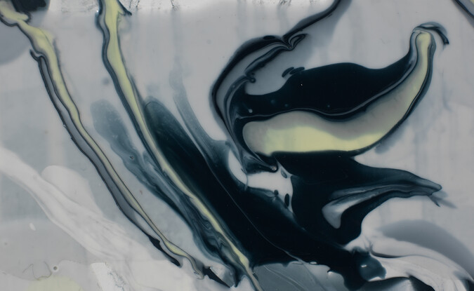 close up of a painting with monochromatic shiny paint that looks like it's fluid and moving