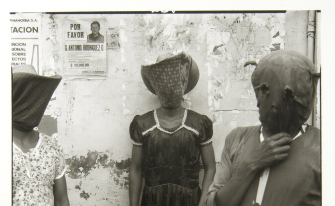 3 hooded figures standing front facing outdoors
