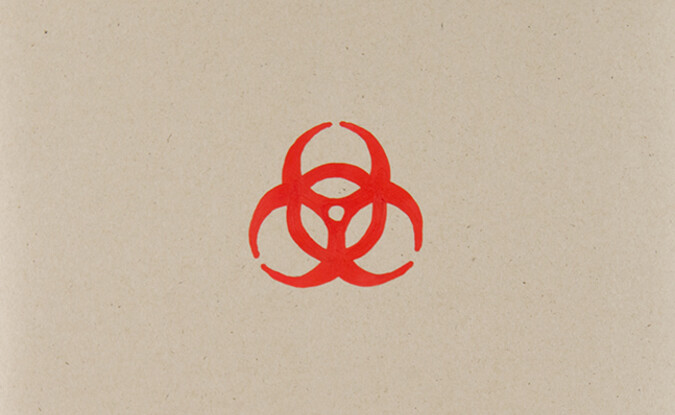 Red hazard sign on cardboard
