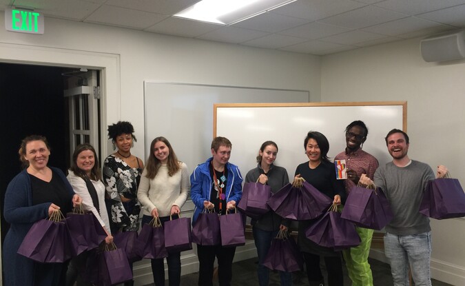 Group of people holding care bags