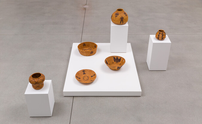 group of 6 baskets on white pedestals