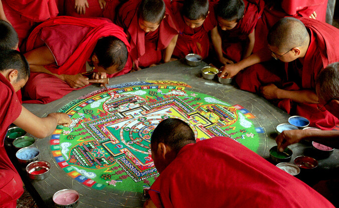 monks creating sand mandala