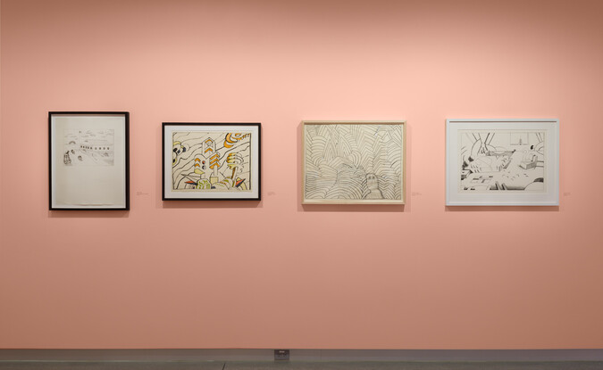 medium shot of framed drawings on pink wall