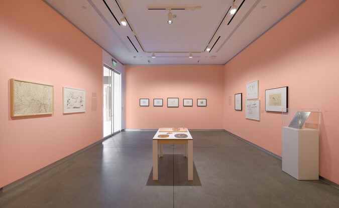wide shot of gallery with pink walls