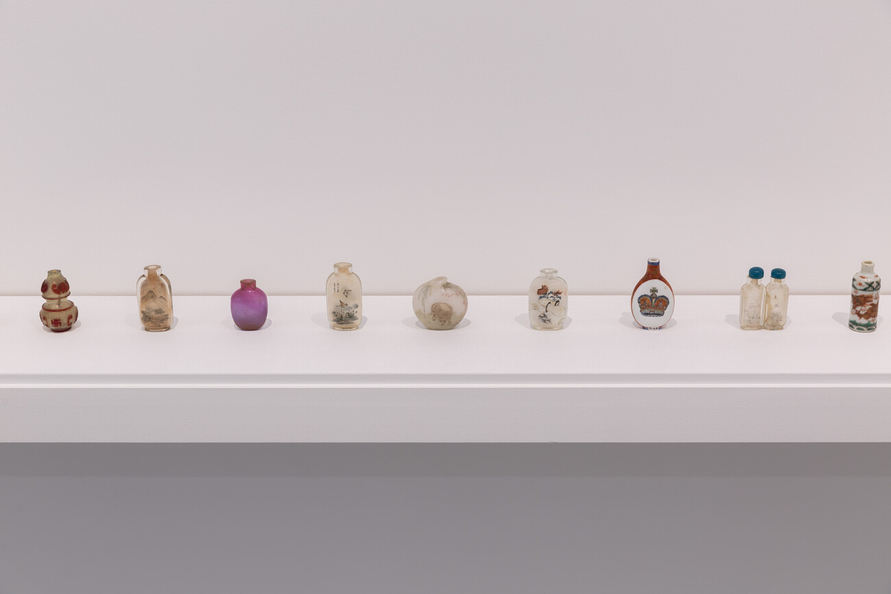 Row of Chinese snuff bottles in gallery space