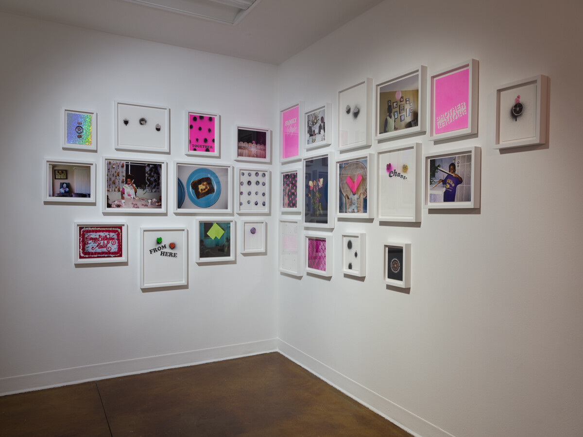 2-wall installation view with multiple framed 2-dimensional works in salon style