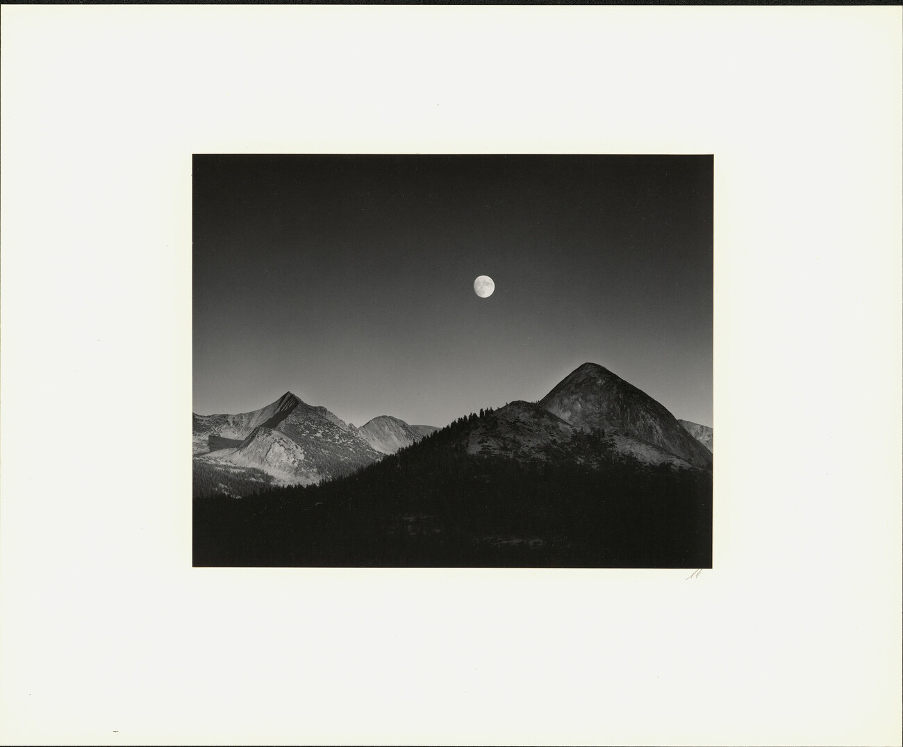 black and white photograph of mountains and moon