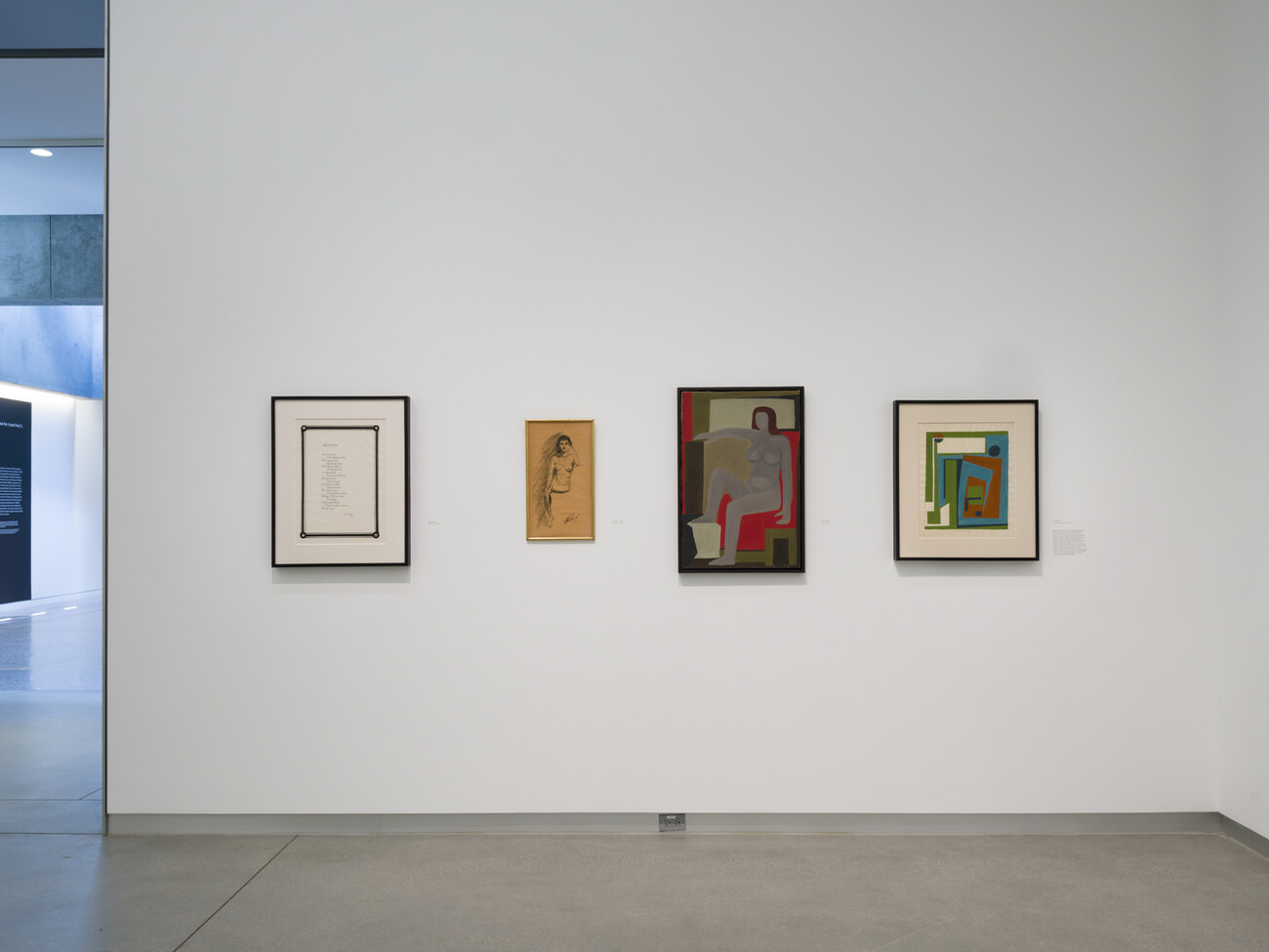 wide shot of gallery wall and artworks