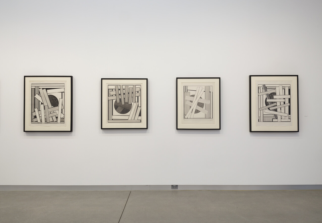 wide shot of gallery wall and framed works