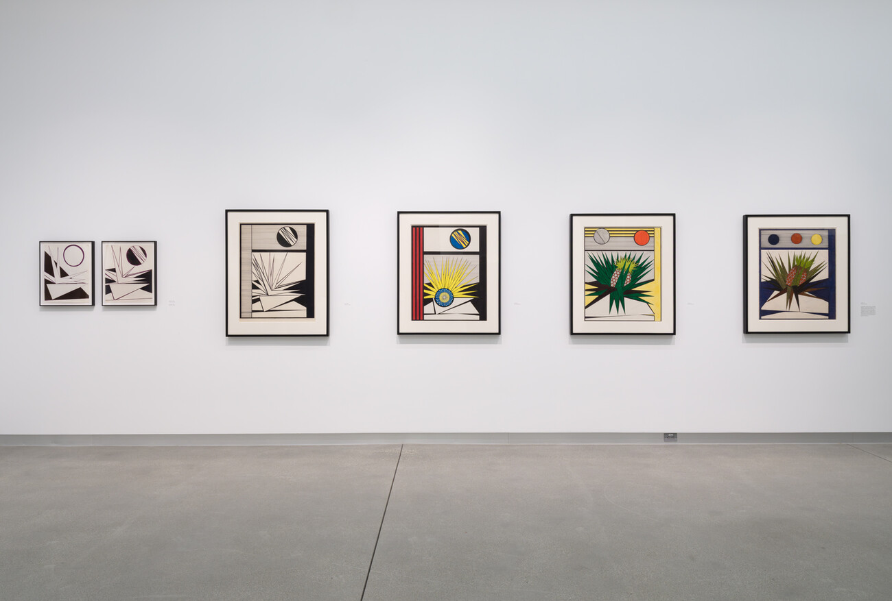 wide shot of five artworks on gallery wall