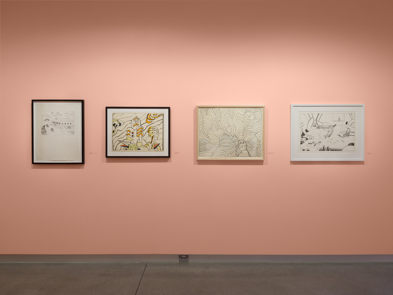 wide shot of artworks on pink wall