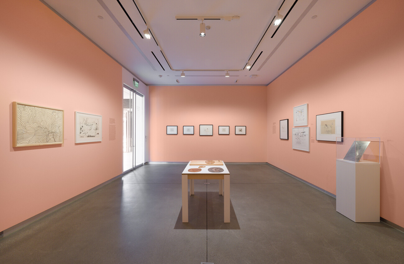 wide shot of gallery with pink walls