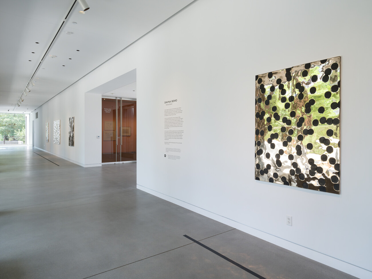 wide shot of art hall with bronze relief hung on the wall