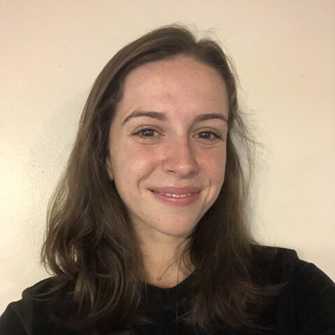 Woman with shoulder length brown hair and black shirt