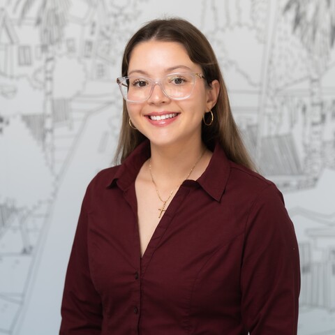woman in glasses smiling at camera