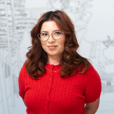 woman in glasses smiling at camera