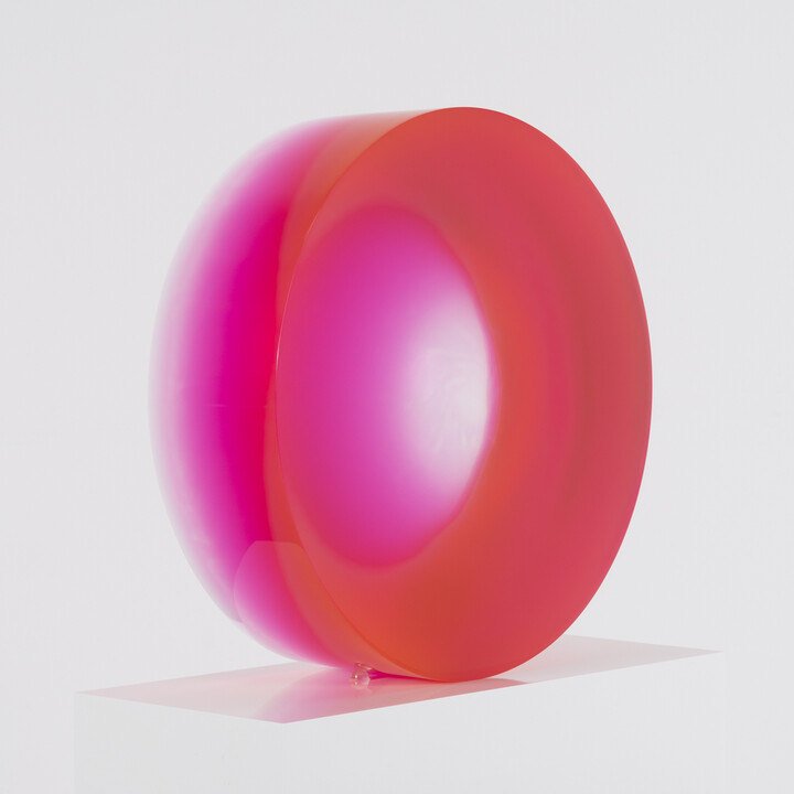 Pink disc on white pedestal