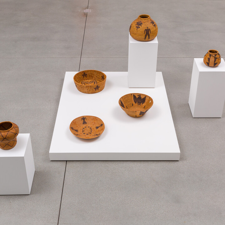 group of 6 baskets on white pedestals