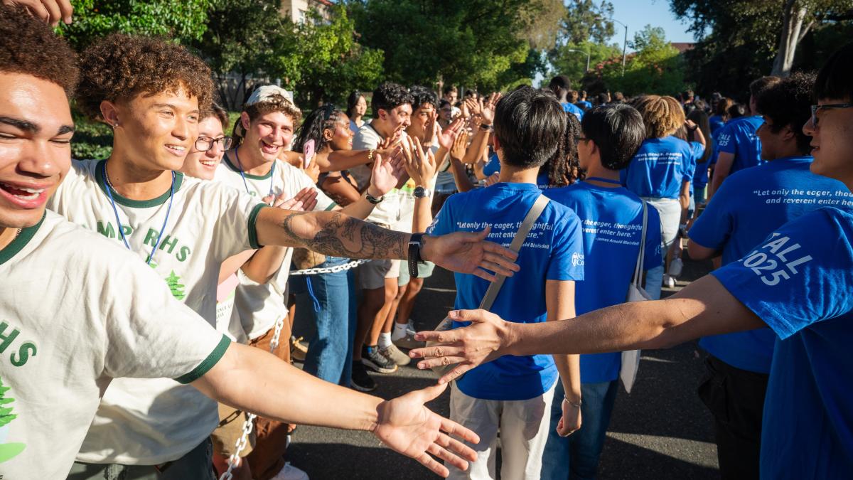 Students giving high fives to other students