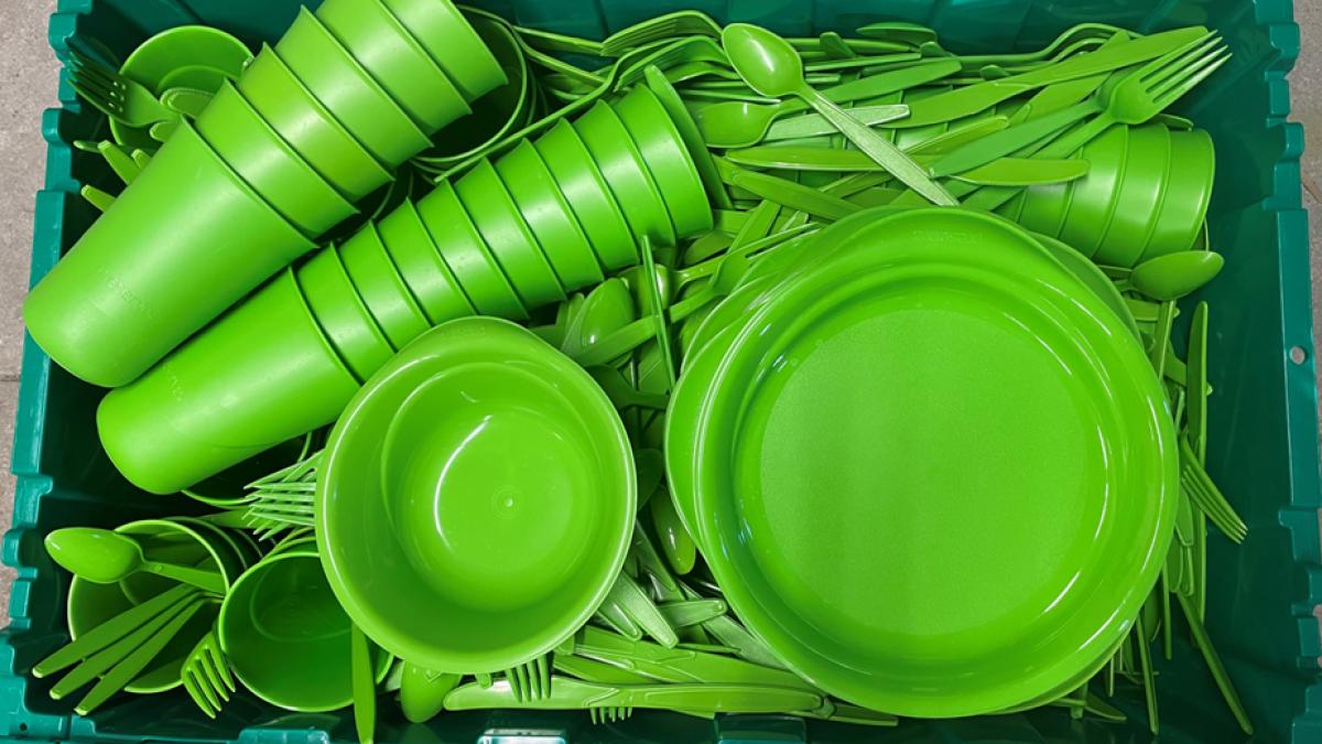 Box filled with reusable plates, cups, bowls and utensils
