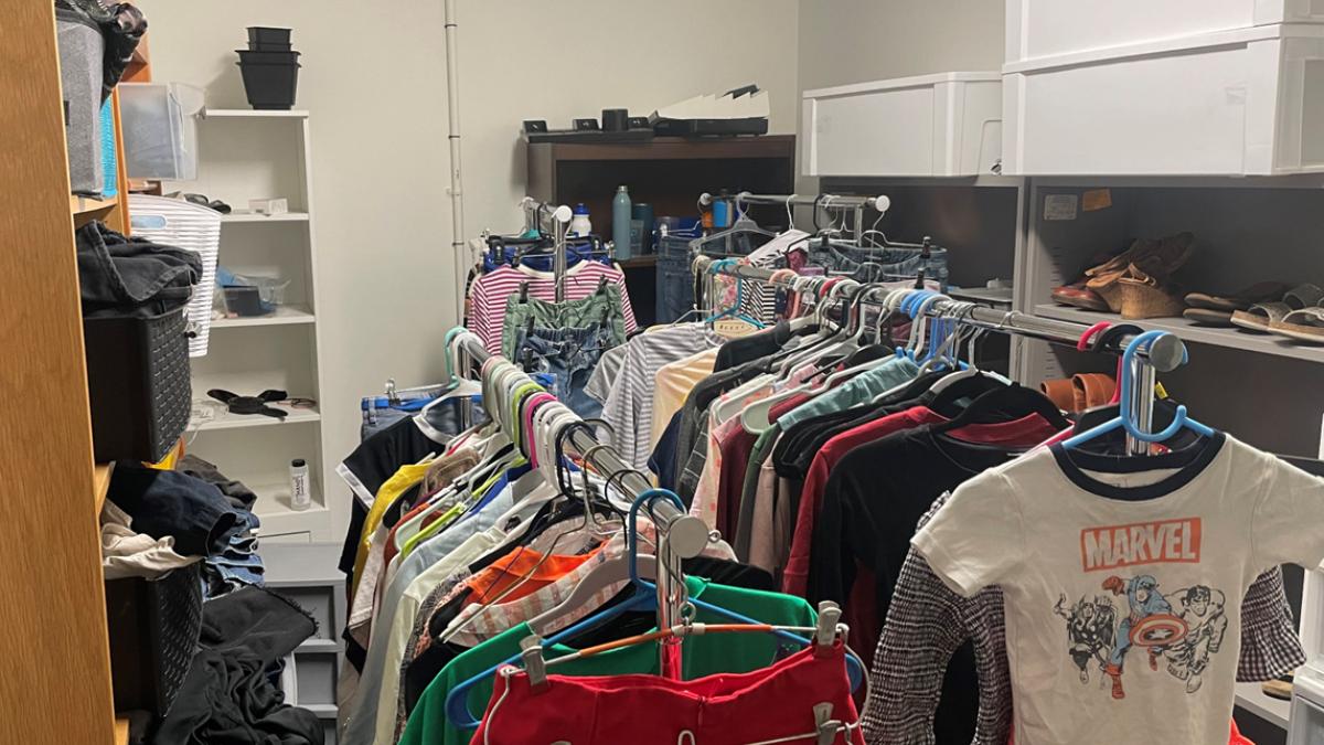 Room with clothing on racks